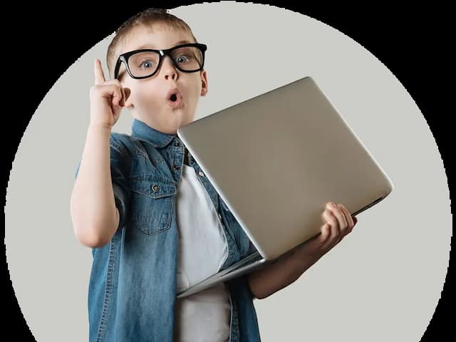 Surprised school-aged boy wearing glasses and holding a laptop, with one finger raised.